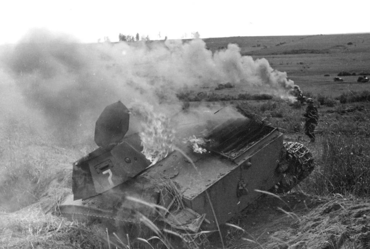 Dislodged turret on a burning Soviet T-60 light tank