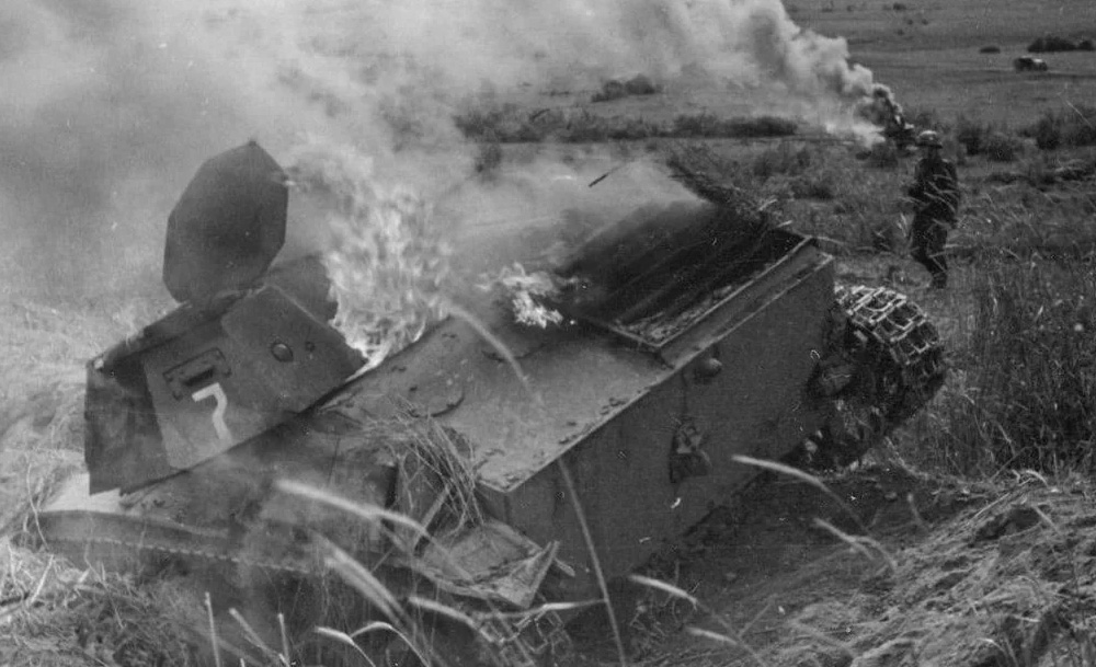 Dislodged turret on a burning Soviet T-60 light tank