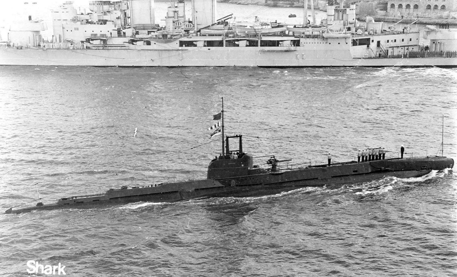 HMS Shark passing HMS Hood in Malta Harbor